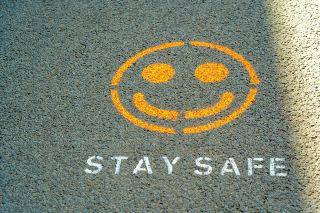 Stay safe sign written on a street