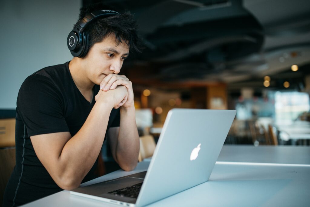 Image showing a person in headphones using a laptop 